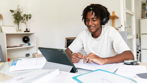 Image of a Man at a desk, studying on his laptop