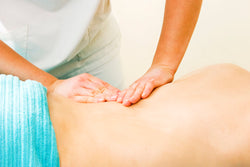 Woman massaging a persons back