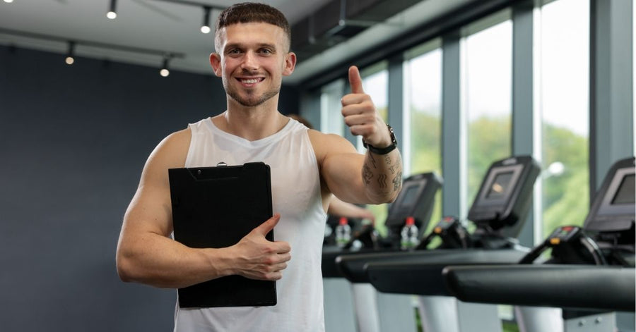 Personal trainer with a clipboard in a gym